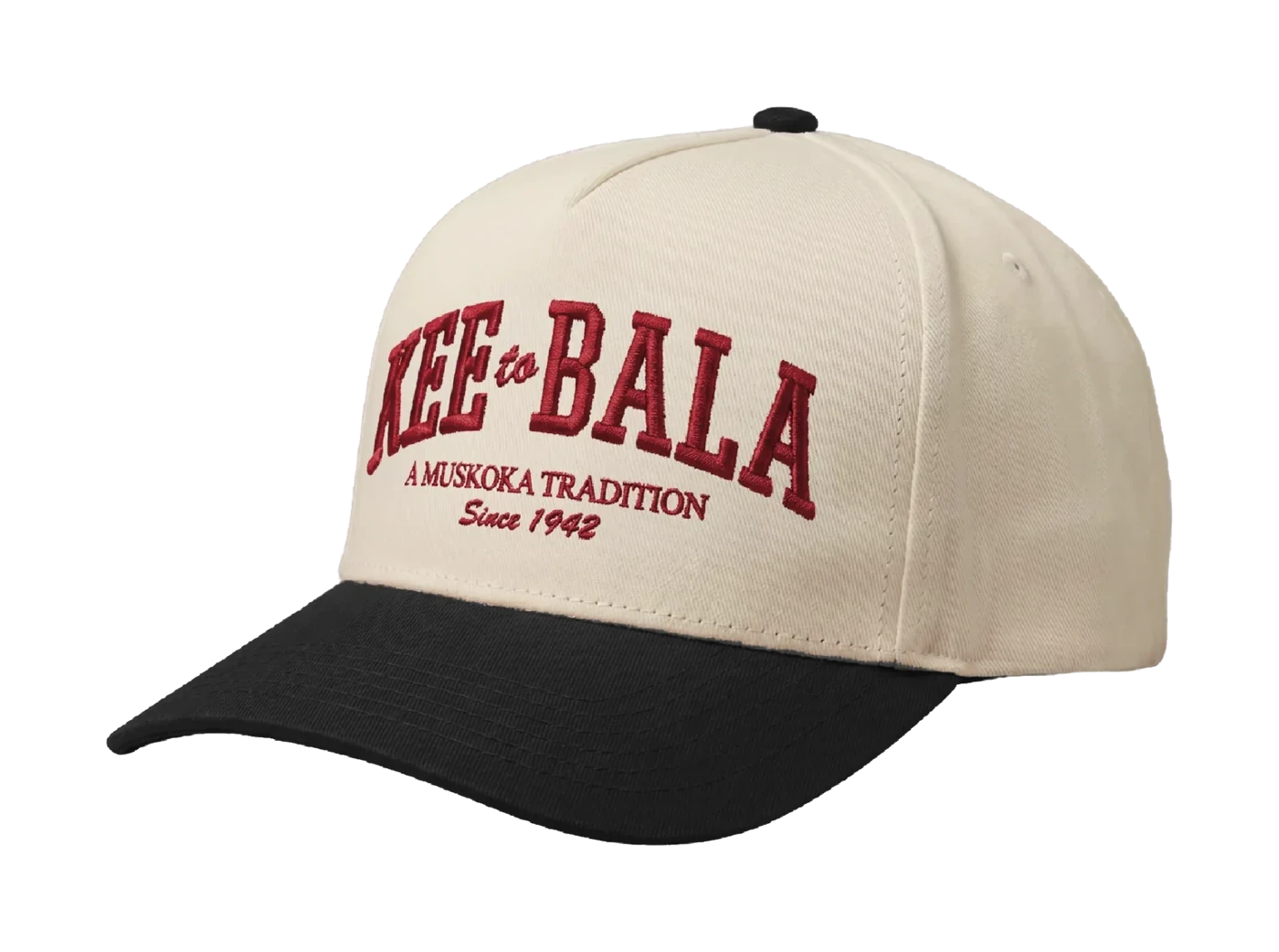 Cream snapback with a black brim and 3D embroidered lettering