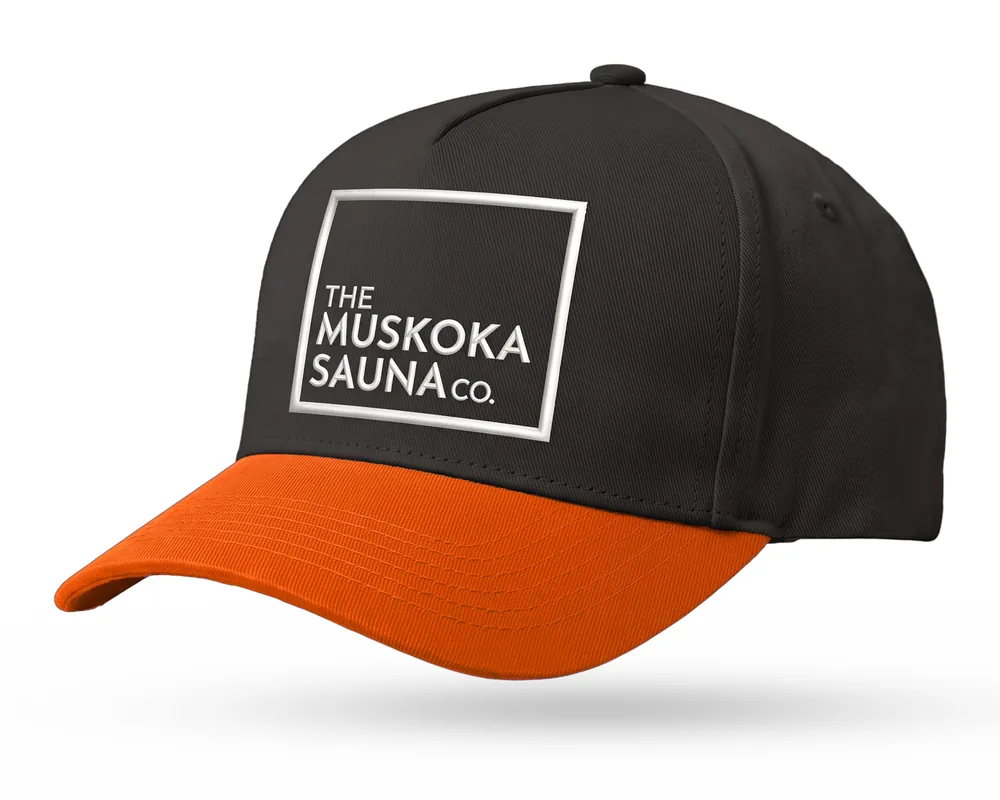 The Muskoka Sauna Co custom 5-panel snapback, black crown, ember orange brim, white embroidered square logo