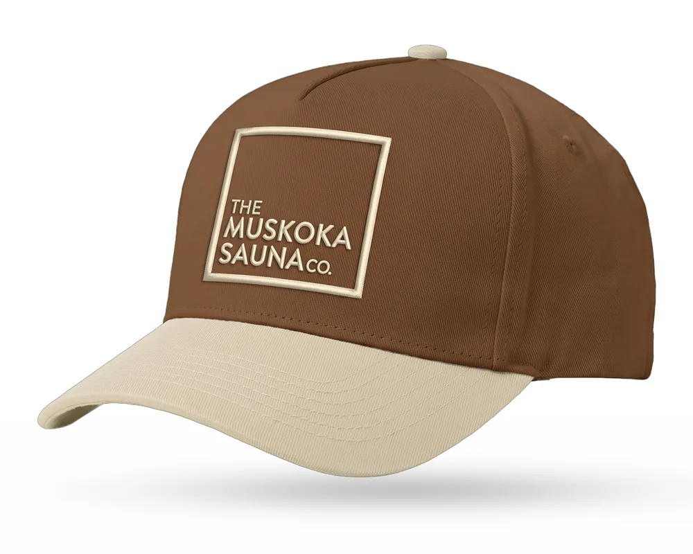 The Muskoka Sauna Co custom 5-panel snapback, cedar brown crown, sand brim, sand embroidered square logo