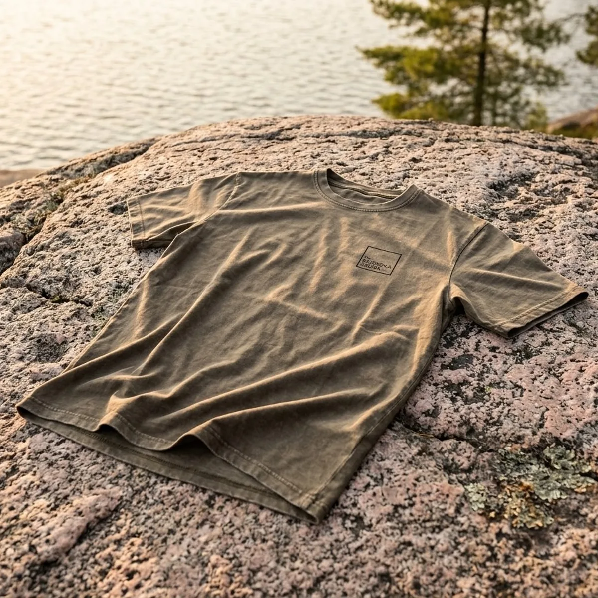 The Muskoka Sauna Co vintage tee laid on Canadian Shield rock by a lake