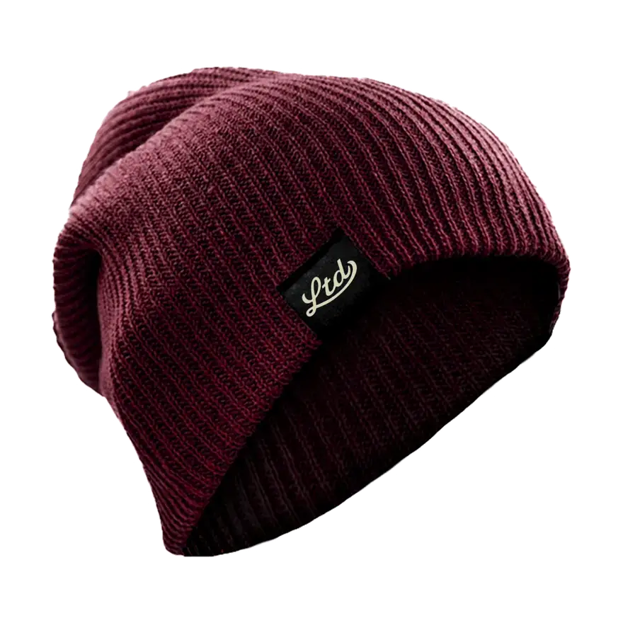 Slouch beanie with a woven LTD label, changing colour as the page scrolls