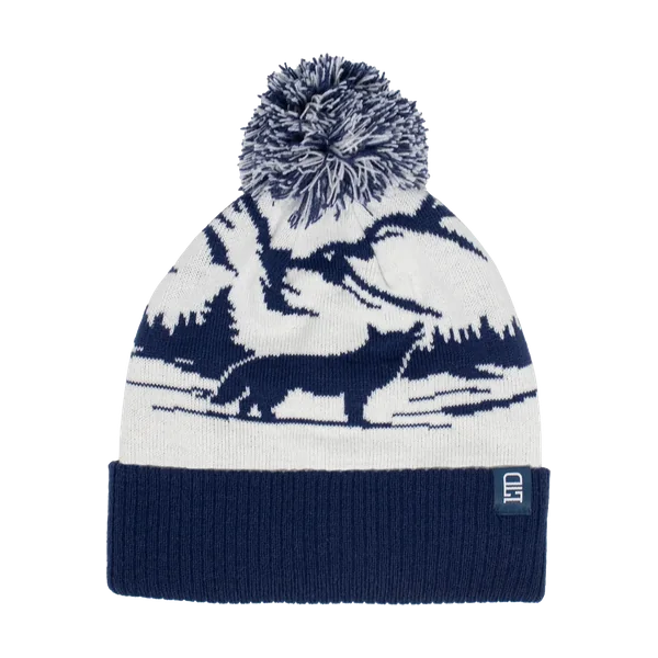 White and navy jacquard toque with a pom and a forest scene